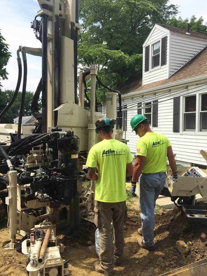Nick Kolenda (left) and Tom Hartwell, Drillers for Active Environmental Technologies, use a 3230DT to install 2-inch monitoring wells in a residential area.  Monitoring wells were installed to determine potential groundwater impact.  