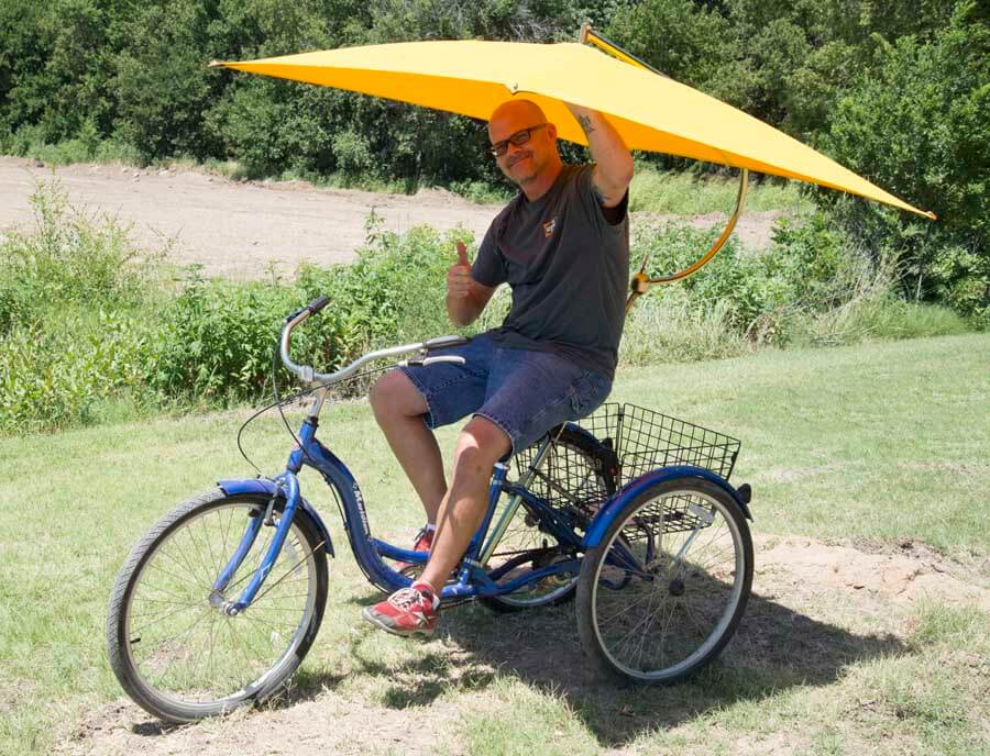 Name: The Trike - Dave Golden ... Tools Group Draftsman - Couldn’t Pass up a used trike ... with a basket ... and it’s a Schwinn! “When we ride the Trike we get to relive our childhood!” THE bike of choice for heavy parts or hauling large casing, such as 80 lb. 2-ft. long 10-in. casing. Has also carried an entire set of fixturing for lift cap destruction testing (200 lb.) while pulling a trailer (needed a push to get started, but made the trip!) Kansas summers get pretty hot so the umbrella is a bonus. 