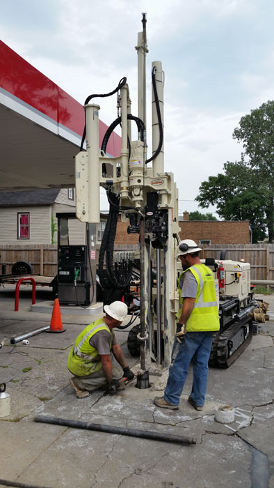 Daniel Fisher (left) and Robert Albinger, Horizon Construction & Exploration, remove the inner drill string to allow an open and cased hole for easy installation of Cathodic Anode.