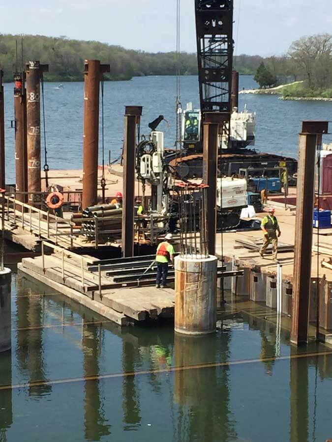 The Field Team for Major Drilling in Salt Lake City, UT, was actually not in the field but on the water for the installation of de-watering wells inside a cofferdam near Des Moines, IA. The goal of the work was to relieve any hydrostatic pressure that may exist.