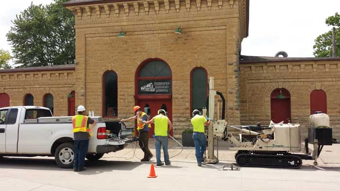 Members of GSI Engineering of Wichita, KS, and the Kansas Department of Health & Environment (KDHE) run an OIP-G log in front of the former Manufactured Gas Plant (MGP) building in Wellington, KS, which has been converted to a railroad museum.  