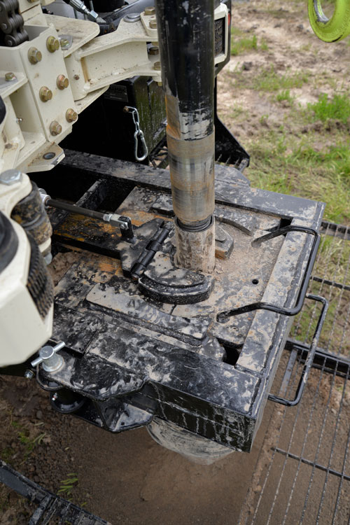 Tripping out is fast with air-powered holding fork and hydraulically-operated, adjustable breakout wrench on the DM450 deep water well drilling rig.