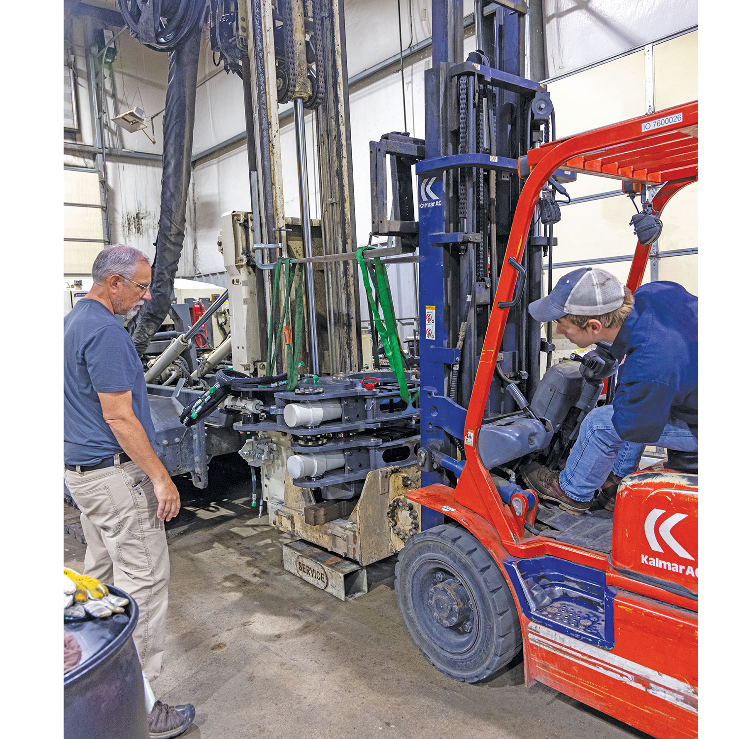 Bourbon assists Nichols positioning the V3 sonic breakout. The new breakout not only increases clamp and twist force but also simplifies service using replaceable components.