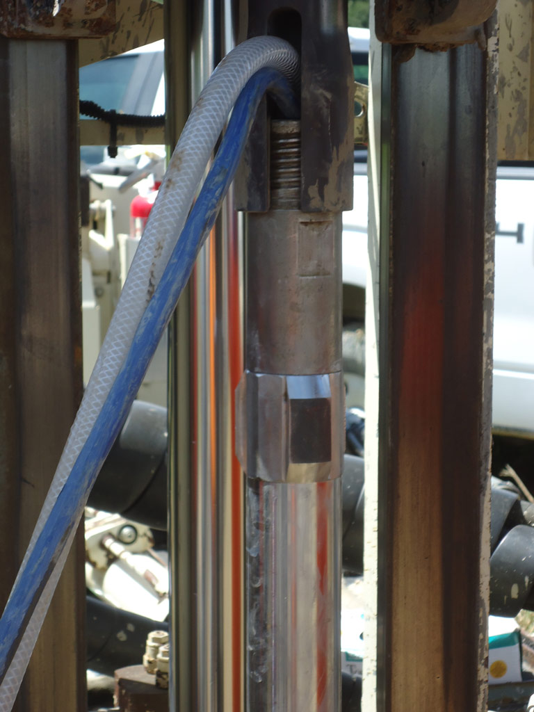 An MiHPT trunkline and grout line connect the probe and grout tool to the surface instruments and grout pump.