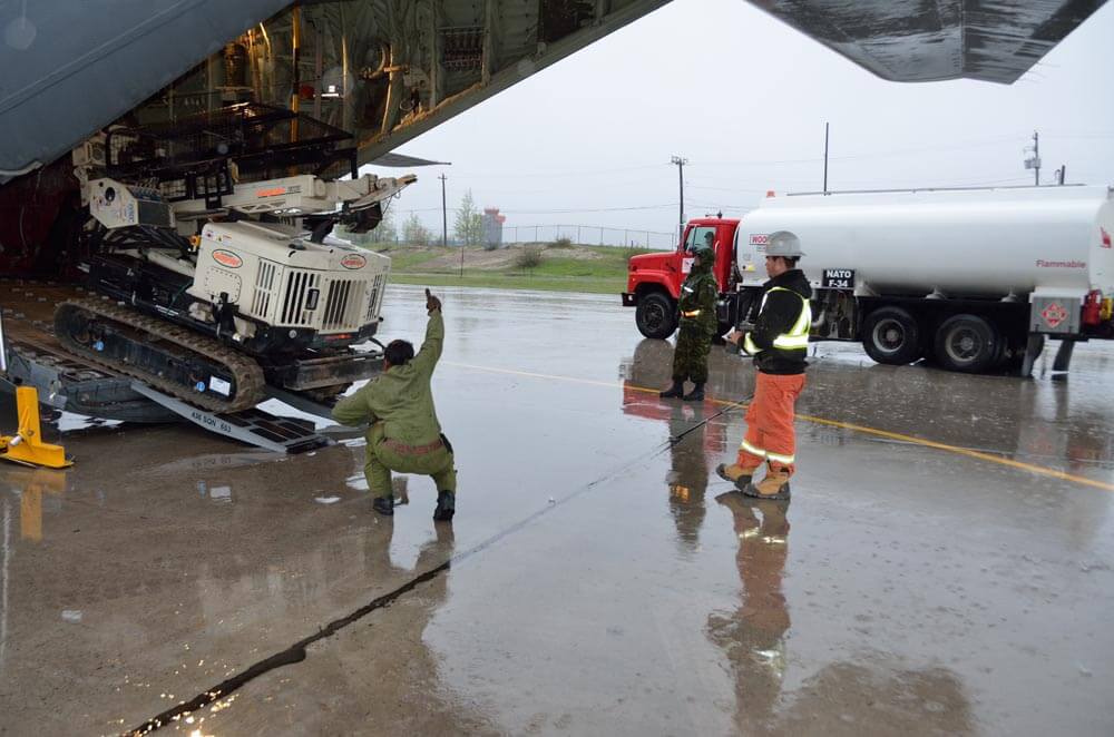 Brandon Stranz, Lead Driller for ALTECH Drilling and Investigative Services, unloads their Geoprobe® 7822DT out of a CC-130 J Hercules at 5 Wing Goose Bay, Newfoundland and Labrador. Altech’s field team operated the 7822DT at the 5 Wing Practice Training Area, an austere military training facility.