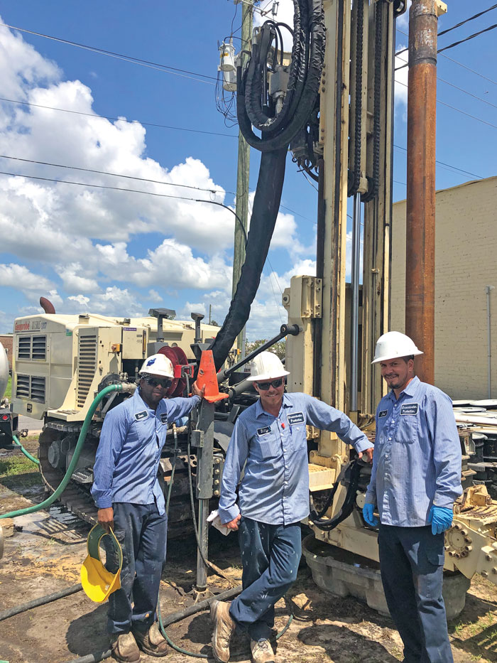 Crew celebrates setting a 2-inch well at 285 feet using sonic drilling technology.