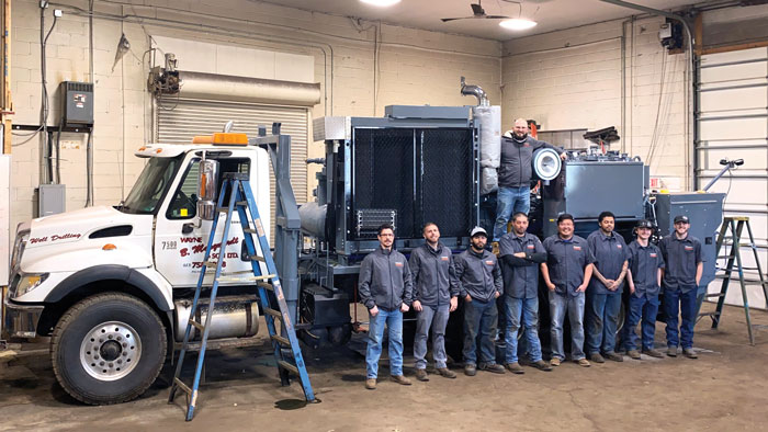 The East Coast Service Center team in front of a drill rig refurbish advanced rig services project.
