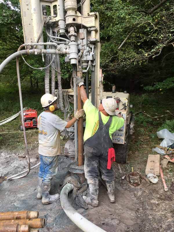 Connor Neely, Driller (left), and Chris Chronister, Eichelberger Field Superintendent, add a drill rod during the 5-in. air percussion drilling.