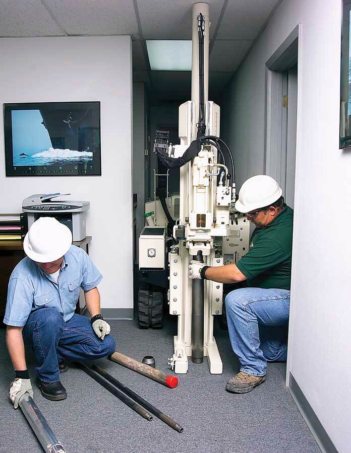 Ray Meinhardt (right) and Bill Seymour set up the GeoTest 54LT for shallow sampling work inside an office building.  At 34.5-in. wide, the 54LT fits through most doorways.