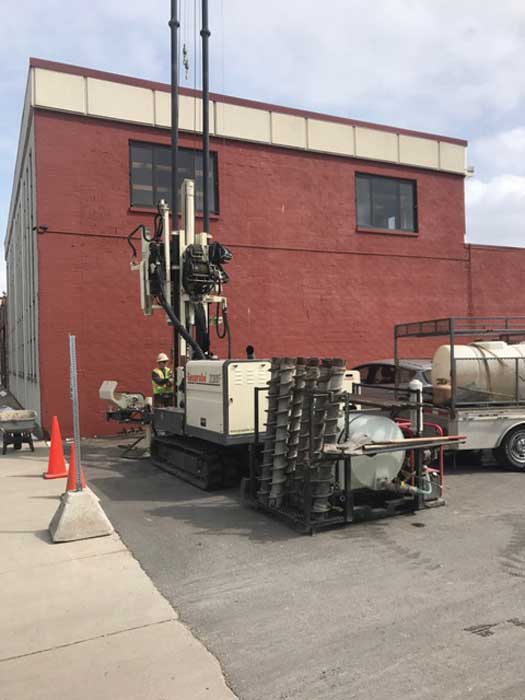Shepler Well Drilling, Inc., completes split spoon sampling every 5 ft. in Traverse City, MI, as part of a geotechnical site investigation. Notice the customer built drop rack that utilizes the 3230DT rear blade to mobilize tools and supplies.  The rack includes a power washer. 