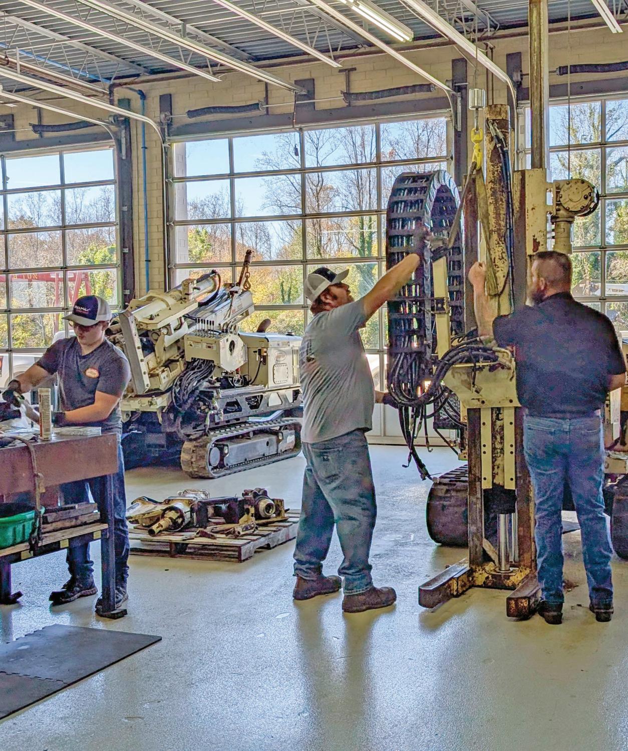 Geoprobe® North Carolina Service Center service technicians use their expertise to keep rigs no longer in production repaired and running in the field. Here they perform a hammer and probe slide changeout.