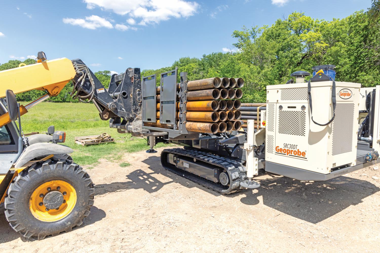 Save sonic rig drilling time using independent quick-attach, 10-foot rod magazines removed using forklift.