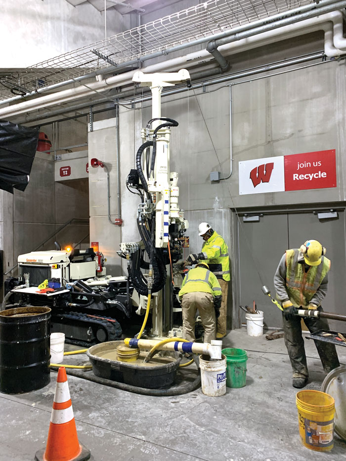 Unlike auger drills, the footprint of 7822DT handles sloped ceilings of bleacher seating at Camp Randall stadium while power permitted completion of mud rotary borings for geotechnical samples.
