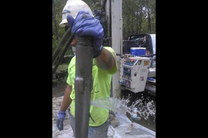 Filling the grout line with water prior to logging