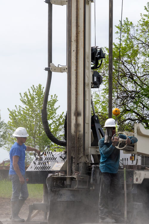 DM250 small water well drilling rigs are easy to operate with a two-man crew. The helper loads the drill pipe in the single road loader using helper-side controls to operate the jib and winch function.