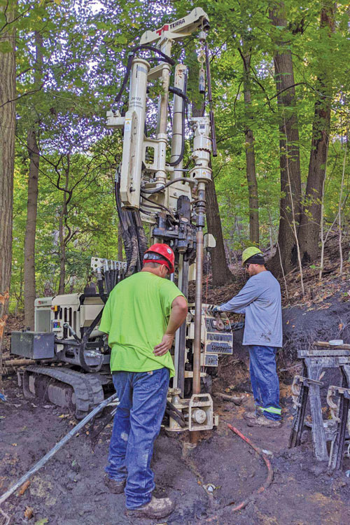 Rotary drilling rigs power for rock coring a geotech boring to 130 feet and multiple 60-foot borings for a road expansion near Pittsburgh completed by running drive casing while taking continuous SPT to refusal around 15 feet and then wireline core to total depth